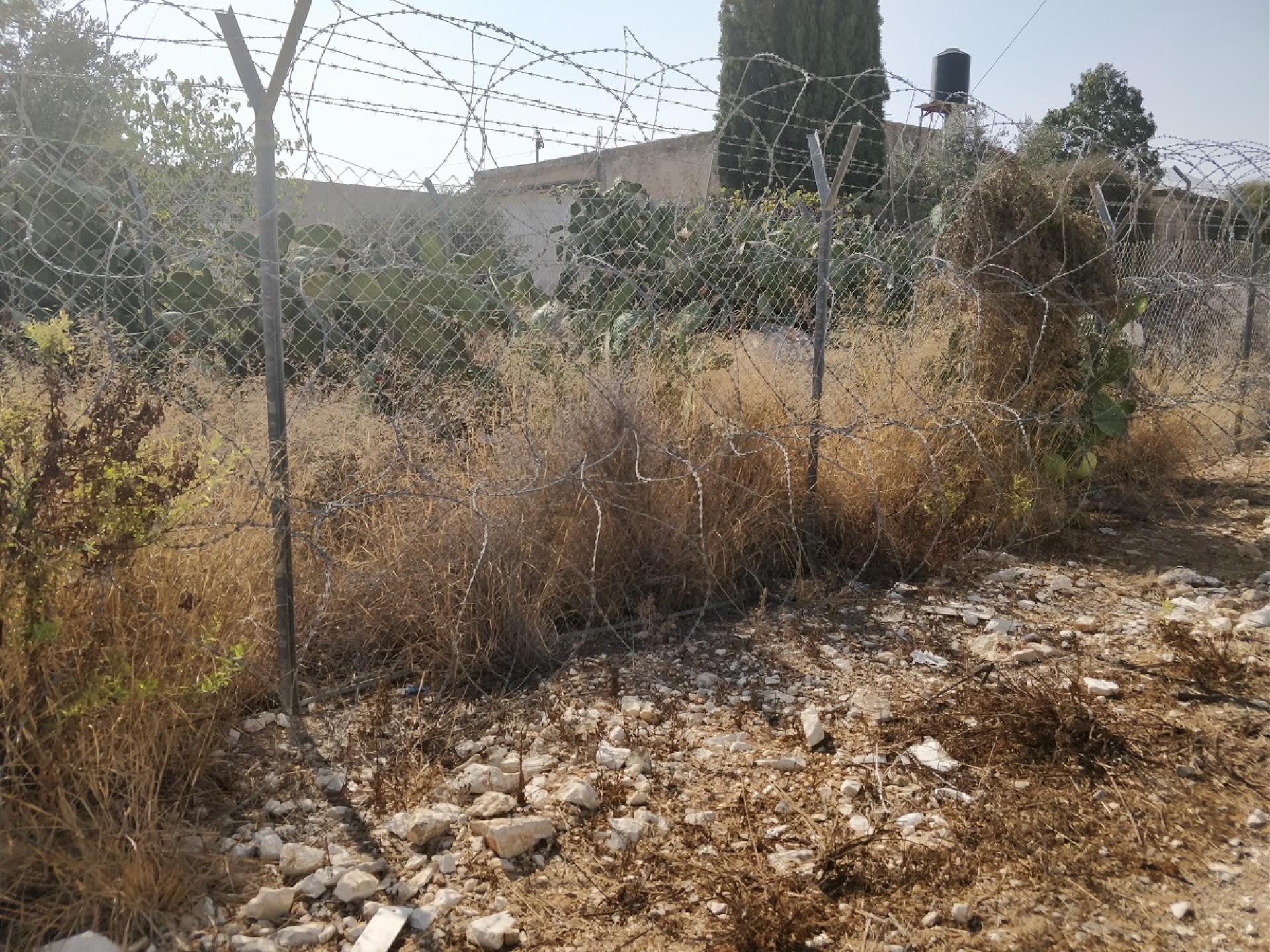 Near the Elkana settler-colony: Hani’s house surrounded with barbed wire fences and high concrete wall