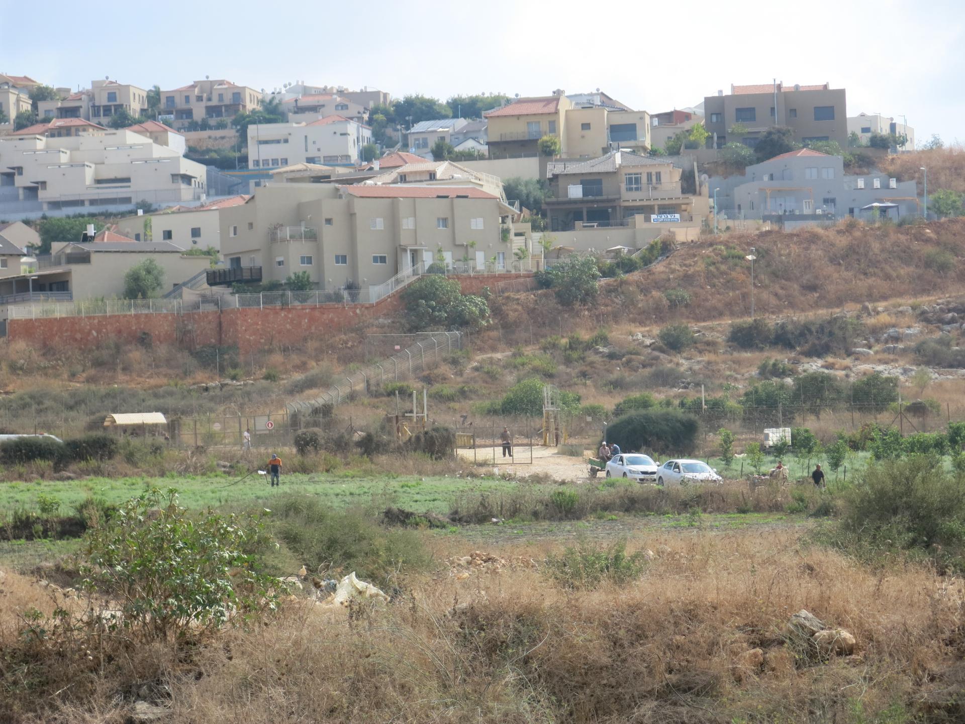 Beit Amin checkpoint against the backdrop of the settlement houses of Oranit