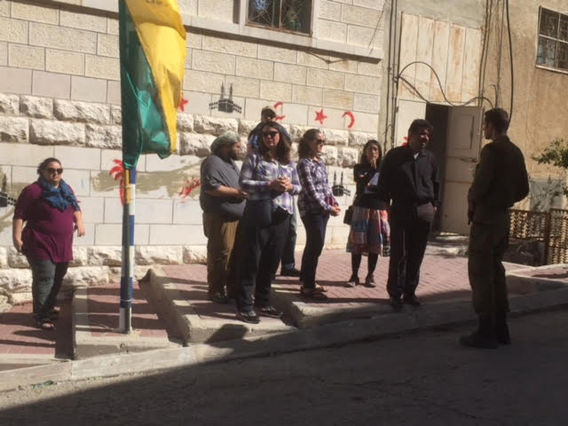 Soldiers hindering a group of Americans with a Palestinian guide from going to Tel Rumeida