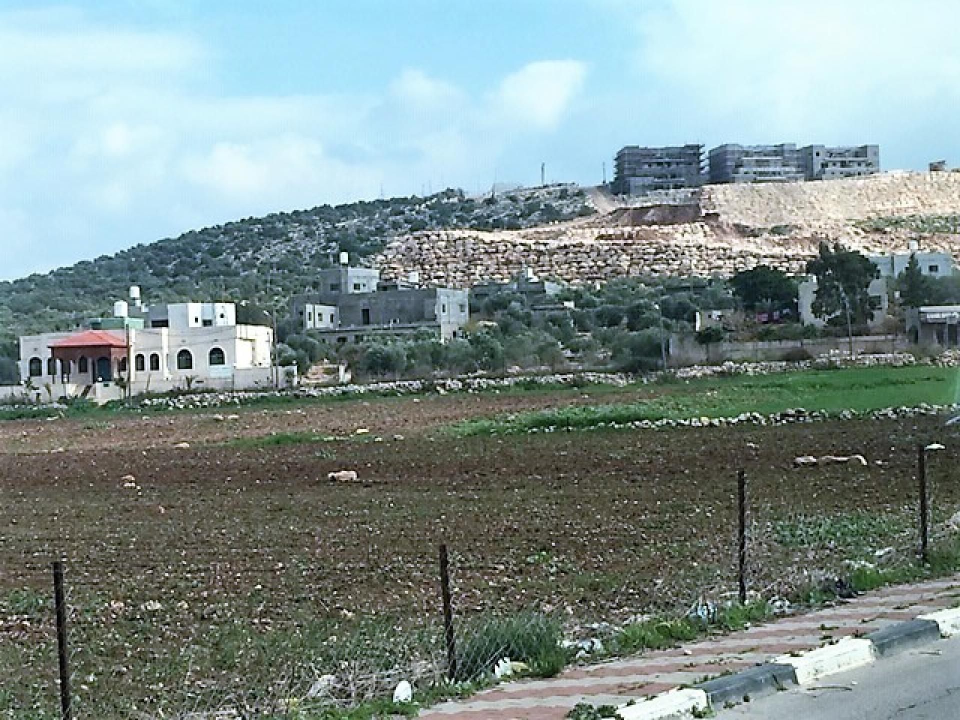 The wall abuts the village’s buildings
