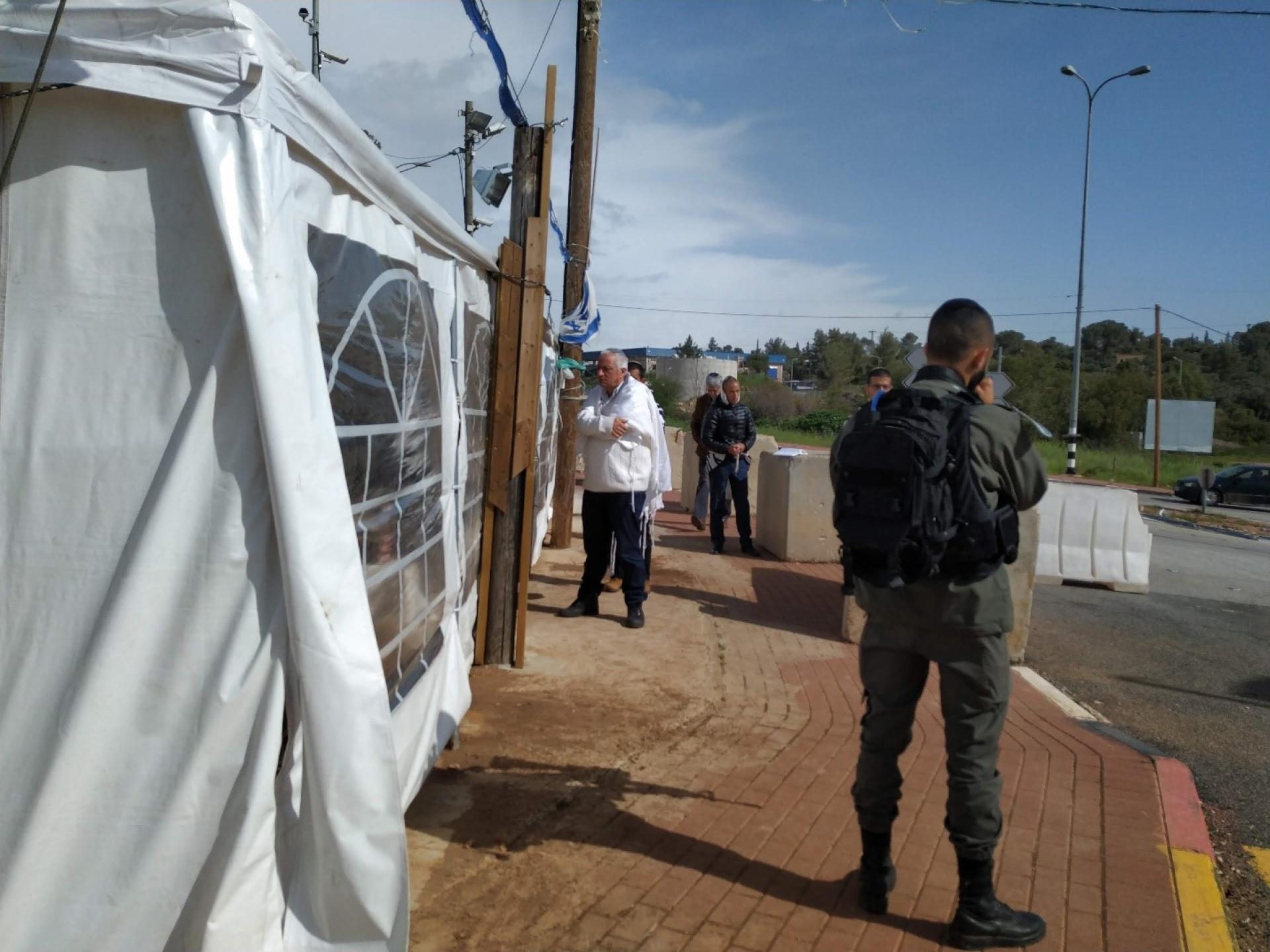 Halameesh Junction: a soldier guarding the entrance of a provisional synagogue tent