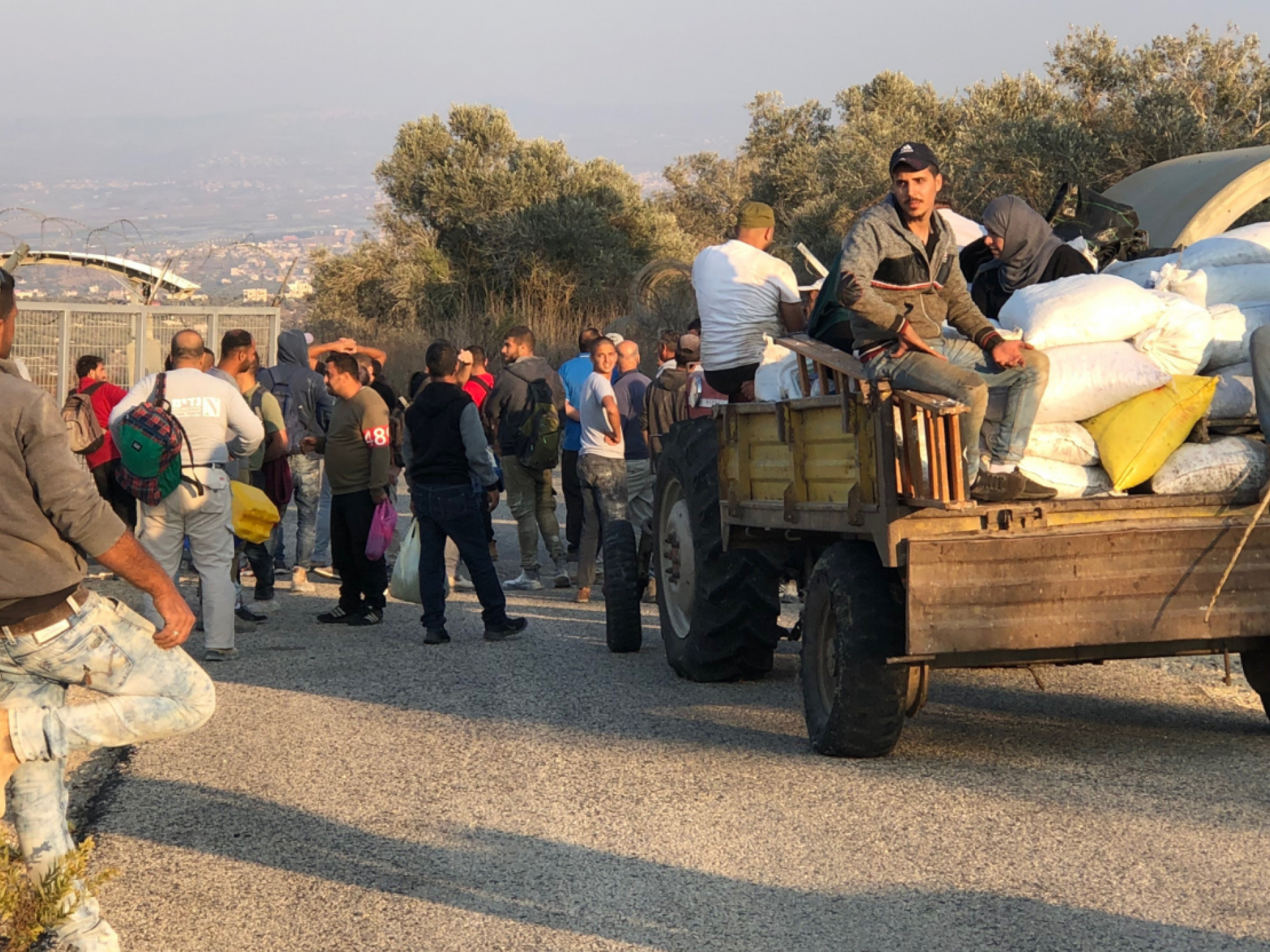 people and a carrige in front of a checkpoint