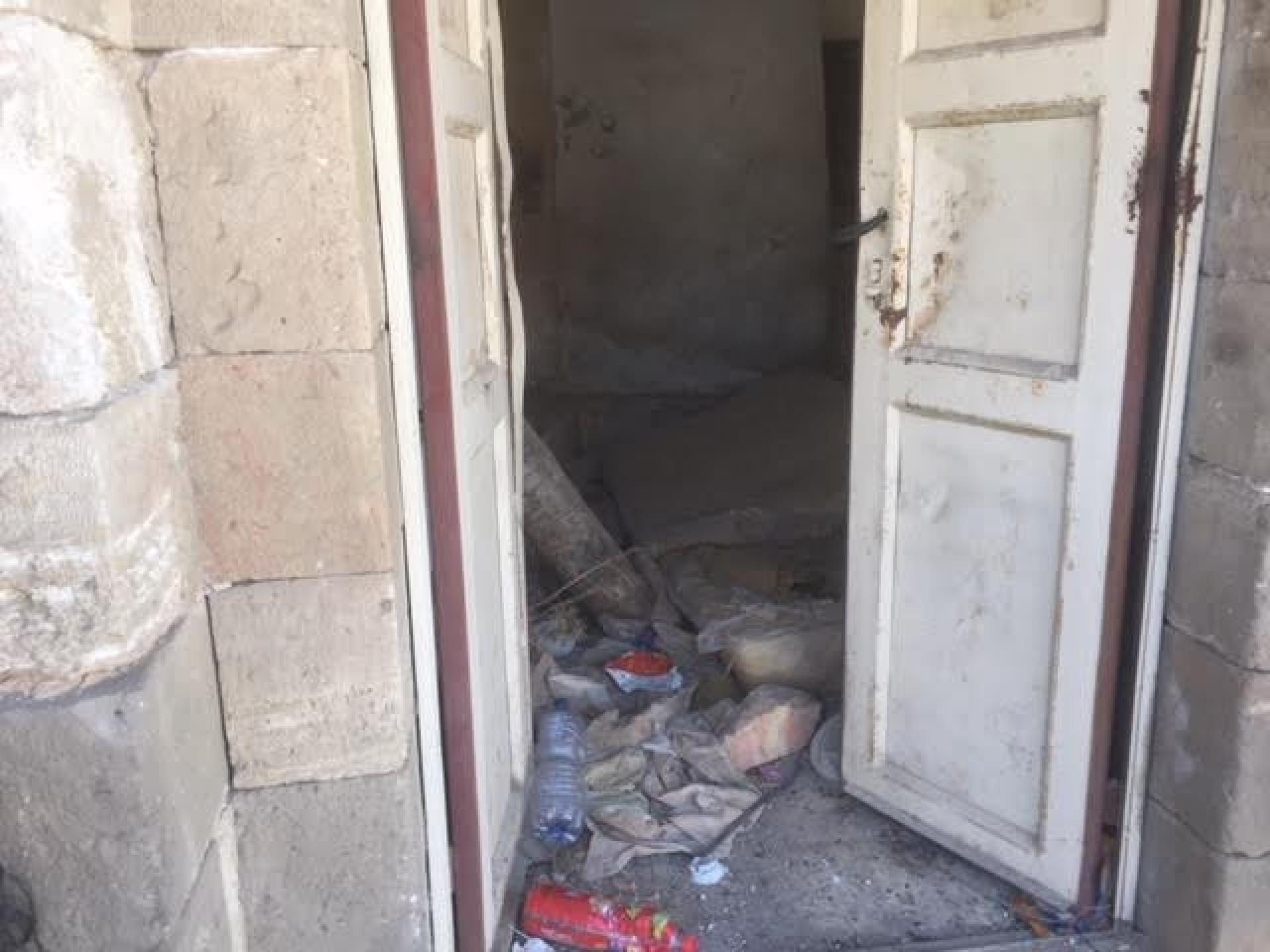 The first house in Shuhada street. The door which had been  welded is open