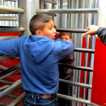   Brothers pass through the checkpoint in Qalandiya