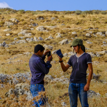 עימות עם מצלמות: נער הגבעות שולף מצלמה אל פני הרועה הפלסטיני, אשר שולף עליו בחזרה
