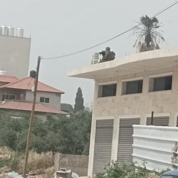 חווארה, חייל מכוון את נשקו לרחוב מגג אחד הבתים