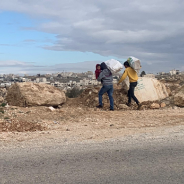 דרום הר חברון - פלסטינים חוצים את הכביש רגלית עם כל הסחורה על גבם ותינוק על הידיים 