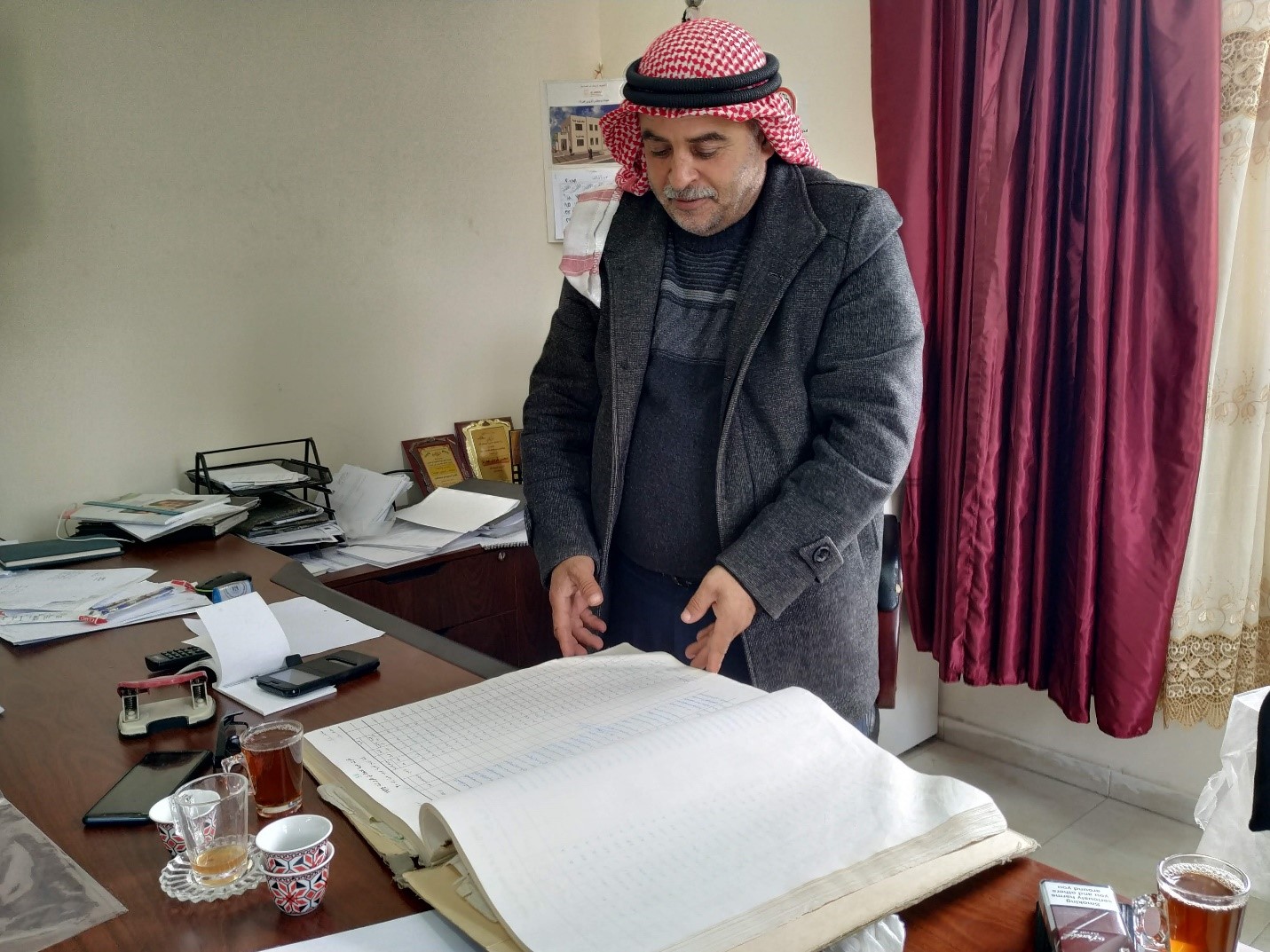 Awarta: the mayor of Awarta with the village lands' registry