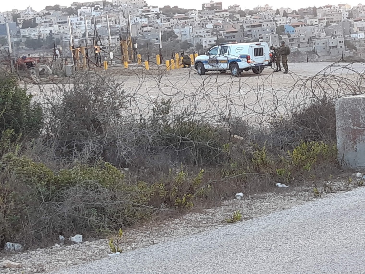 Anin Checkpoint: Soldiers move barriers for 2 farmers on the way to their olive grove