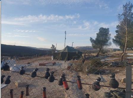 Beta: A protest tent and an exhibition of grenades and  shell casings of bullets fired at them