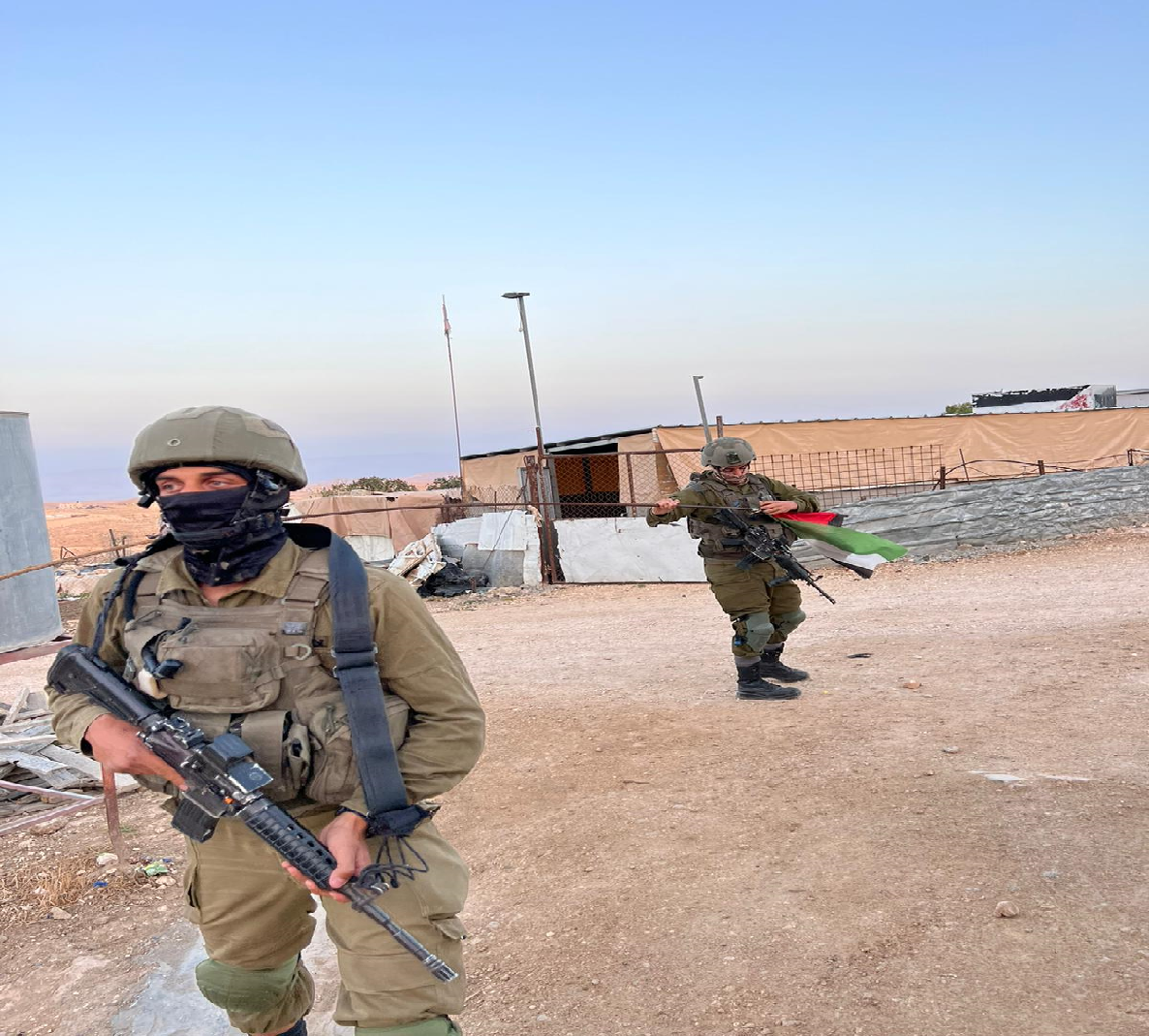 Umm al Kheir - soldries removing the Palestinian fla