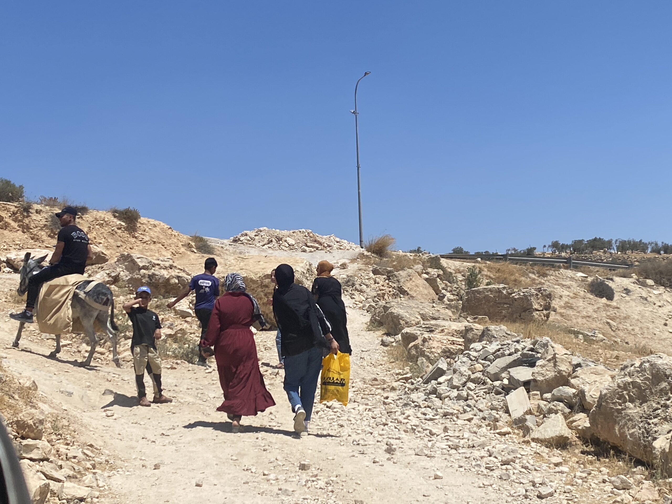 Travelling to the city on a road bypassing dirt barriers