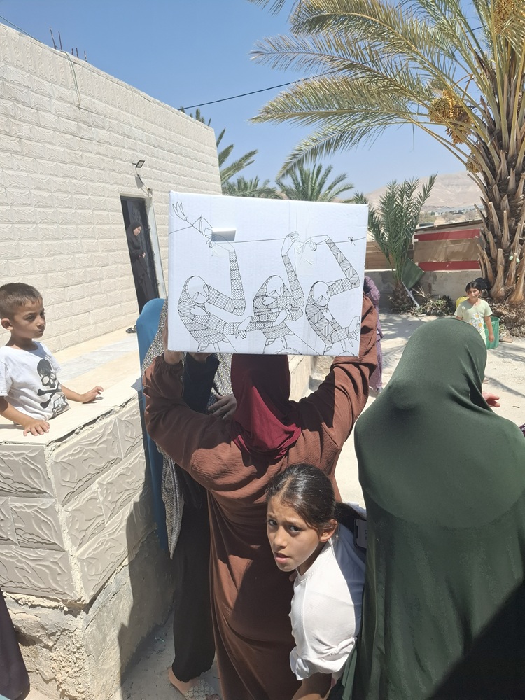 Fassayil Jordan Valley, women and children receive food boxes