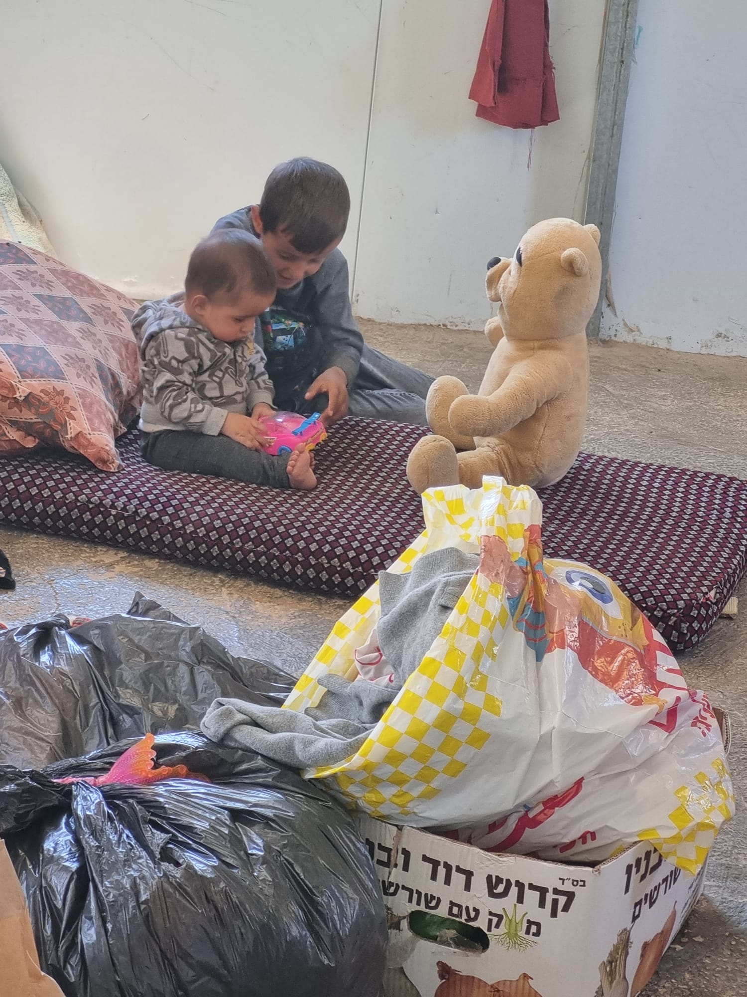 N's children are playing with the games we brought. Umm Qusa