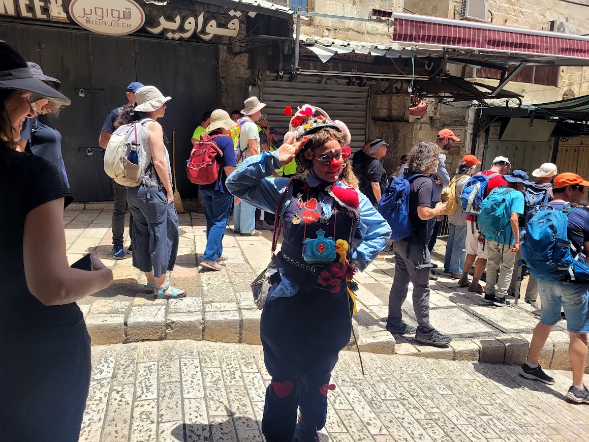 Jerusalem. Az-Olay the clown-cop handing out hearts to police officers and activists