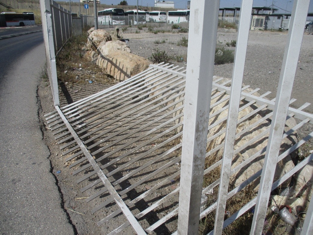 Qalandiya. A breach in the fence creates a shortcut