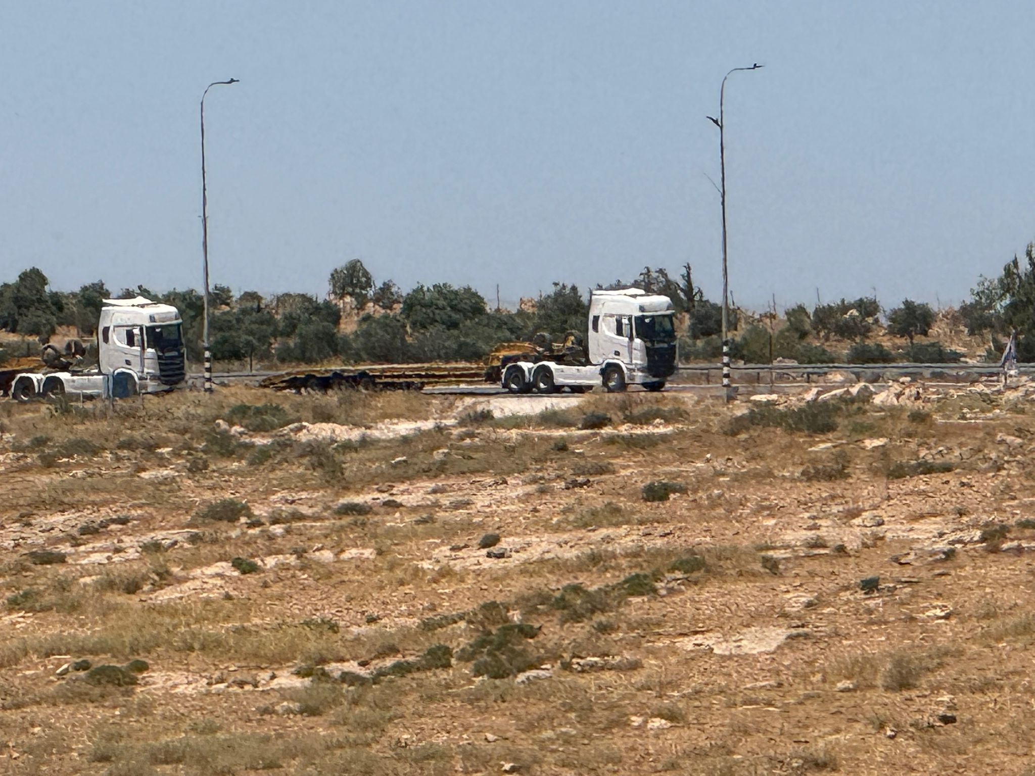 The empty carriers on Route 317 from which the bulldozers that destroyed them descended