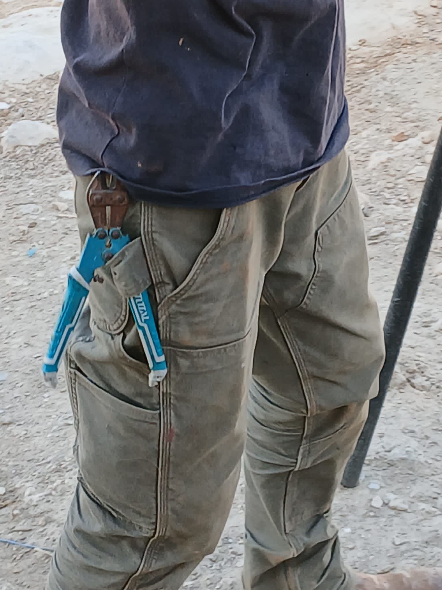 The settler boy is equipped with a shearer and a stick when he comes and curses at the residents.