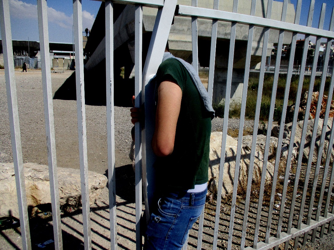 Qalandiya. Squeezing through a narrow opening in the fence