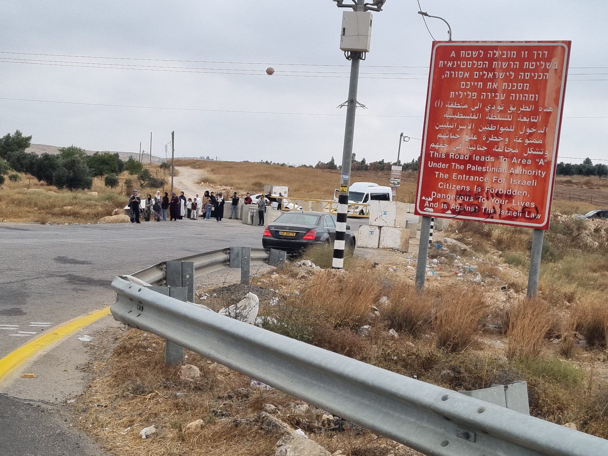 Samu' checkpoint is closed. Local residents are waiting for a minibus to pick them up.