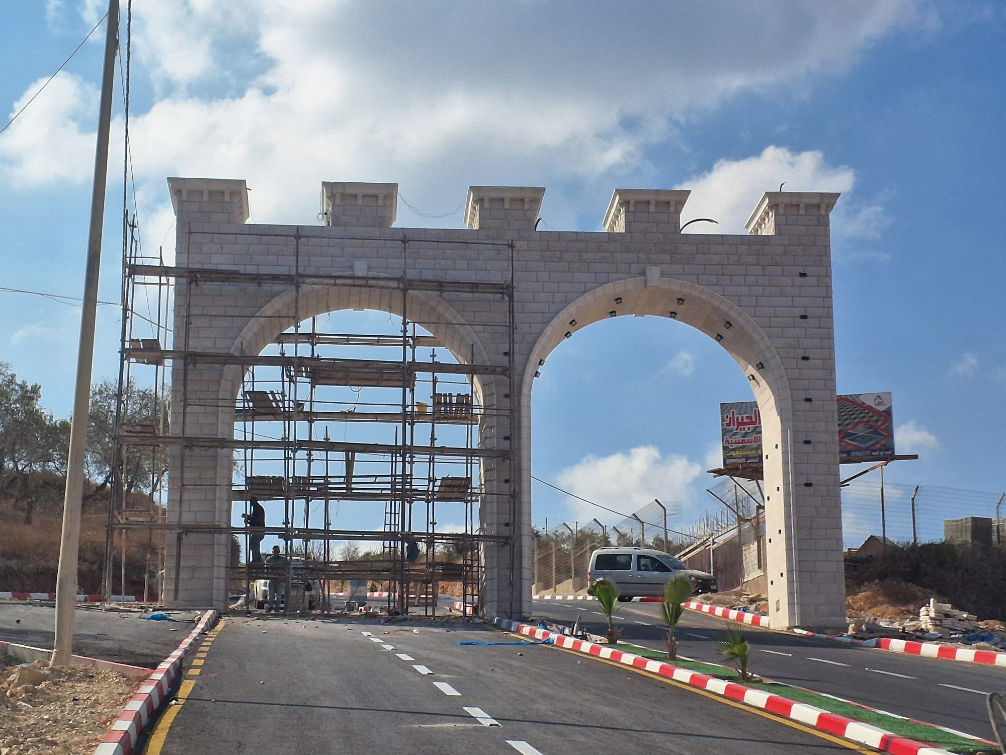 Jurish. A stone gate under construction further up the new road
