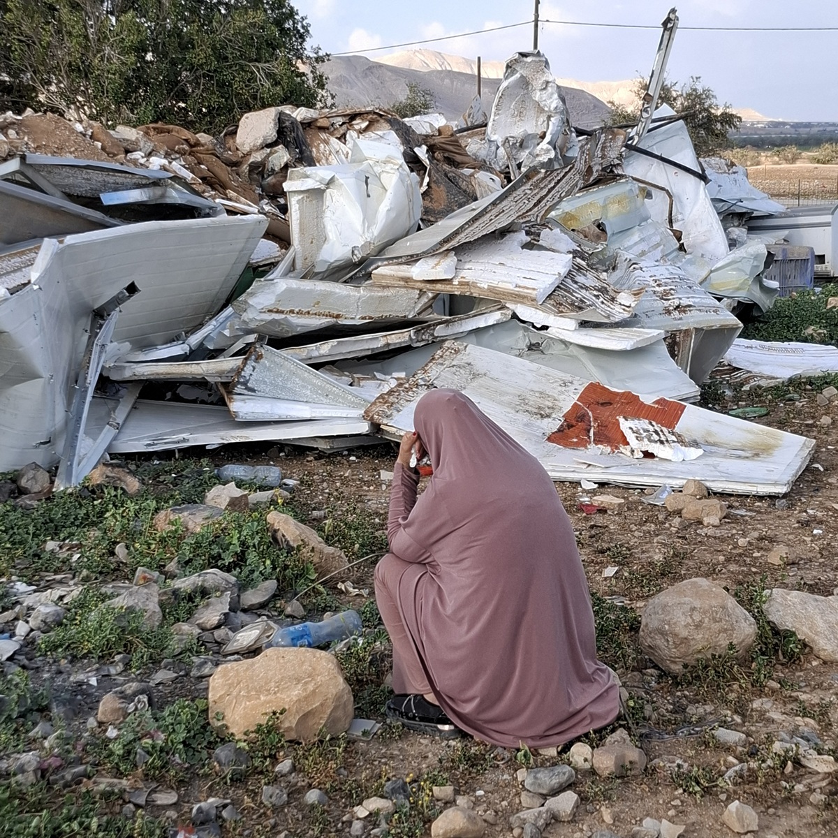 T. laments the ruins of her home.  Fasa'il, Jordan Valley, 
