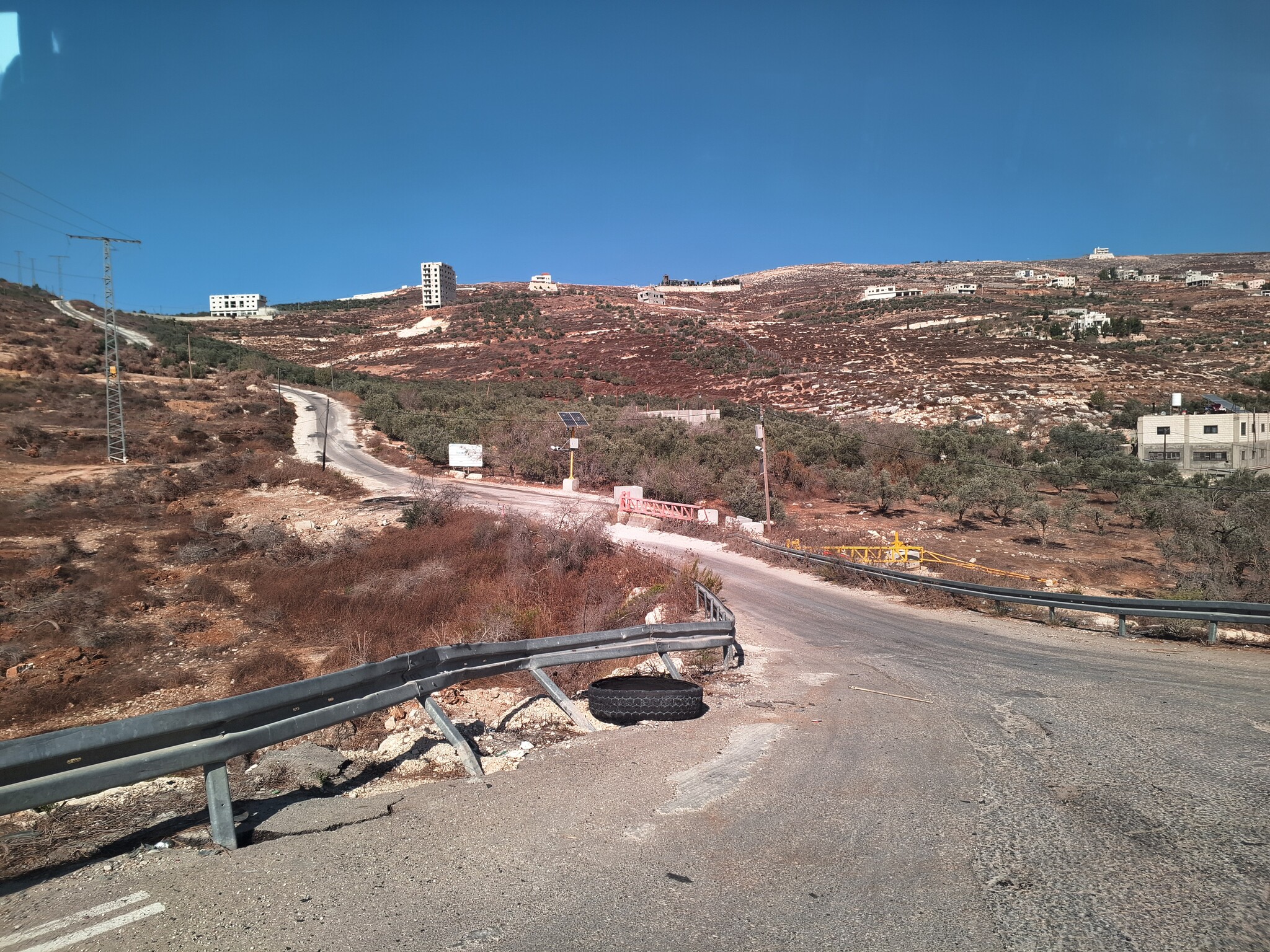 Madama. Road to village center – one gate closed, one open